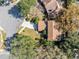 Stunning aerial perspective of the house with lush greenery, landscaping, and a well-kept lawn at 8413 Commander Cv, Winter Park, FL 32792