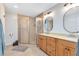 Well-lit bathroom featuring a double sink vanity, framed mirrors, and a glass-enclosed shower at 8413 Commander Cv, Winter Park, FL 32792