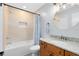 Well-lit bathroom featuring granite countertops, updated fixtures, and a tiled shower-tub combo at 8413 Commander Cv, Winter Park, FL 32792