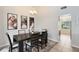 Bright dining room with a modern dark wood table with seating for six, illuminated by a stylish chandelier at 8413 Commander Cv, Winter Park, FL 32792