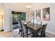 Dining room with a dark wood table, seating for six, and sliding glass door to the outdoor patio at 8413 Commander Cv, Winter Park, FL 32792