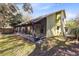 Charming exterior view of the house with a screened porch and a well-maintained lawn at 8413 Commander Cv, Winter Park, FL 32792