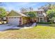 Charming two-story home with attached garage and a well-manicured front yard with mature trees at 8413 Commander Cv, Winter Park, FL 32792