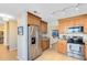 Well-lit kitchen with stainless steel appliances, light-colored cabinets, and a view into the adjacent living area at 8413 Commander Cv, Winter Park, FL 32792