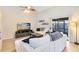 Cozy living room featuring a comfortable white sectional, vaulted ceilings, and a sliding glass door at 8413 Commander Cv, Winter Park, FL 32792