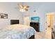 Bright main bedroom boasting a ceiling fan, tiled floors, and an en-suite bathroom at 8413 Commander Cv, Winter Park, FL 32792