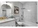 Updated bathroom featuring white marble tiled shower/tub and granite vanity at 8523 Fort Clinch Ave, Orlando, FL 32822