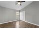 Spacious bedroom with wood-look tile floors, ceiling fan, and closet at 8523 Fort Clinch Ave, Orlando, FL 32822