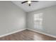 Bright bedroom with wood-look tile floors and ceiling fan at 8523 Fort Clinch Ave, Orlando, FL 32822