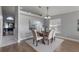 Cozy dining room shows a table set for six, with a view into another living space beyond at 8523 Fort Clinch Ave, Orlando, FL 32822