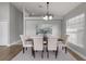 Lovely dining room with six tufted chairs, modern lighting fixture, and neutral decor at 8523 Fort Clinch Ave, Orlando, FL 32822