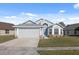 Charming single-Gathering home featuring a well-maintained lawn and attached two-car garage at 8523 Fort Clinch Ave, Orlando, FL 32822