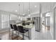 Beautiful kitchen boasts an island with barstool seating, stainless appliances, and sleek white cabinetry at 8523 Fort Clinch Ave, Orlando, FL 32822