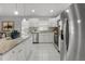 Well-lit kitchen with granite countertops, stainless steel appliances, and a view into the connected living space at 8523 Fort Clinch Ave, Orlando, FL 32822