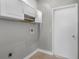 Functional laundry room includes overhead storage cabinets and tile floors at 8523 Fort Clinch Ave, Orlando, FL 32822