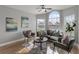 Comfortable living room featuring tile floors, seating, and a large arched window at 8523 Fort Clinch Ave, Orlando, FL 32822