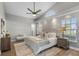 Serene main bedroom with vaulted ceiling, large windows, and a neutral color palette at 8523 Fort Clinch Ave, Orlando, FL 32822