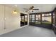 View of enclosed patio with sliding glass doors, exterior light fixture and concrete flooring at 8523 Fort Clinch Ave, Orlando, FL 32822