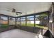 Enclosed patio with ceiling fan overlooking a fenced backyard with a large grassy area at 8523 Fort Clinch Ave, Orlando, FL 32822