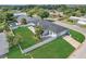 Aerial view of a well-maintained home with lush green lawn and a fenced yard at 867 N Halifax Dr, Ormond Beach, FL 32176