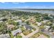 Aerial view of a neighborhood, showcasing houses with lush greenery and waterfront views and access at 867 N Halifax Dr, Ormond Beach, FL 32176