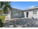 Exterior view of the backyard with a brick patio and access to the home at 867 N Halifax Dr, Ormond Beach, FL 32176