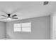 Bright bedroom featuring a ceiling fan, a large window, and neutral paint at 867 N Halifax Dr, Ormond Beach, FL 32176