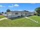 Beautiful gray brick home featuring a lovely stone walkway leading to the front door, with well-kept green grass at 867 N Halifax Dr, Ormond Beach, FL 32176