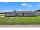 Single-story home featuring a well-manicured lawn and a gray brick facade, with a lovely stone walkway at 867 N Halifax Dr, Ormond Beach, FL 32176