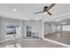 Cozy living room showcasing a stone fireplace, updated flooring, and a modern ceiling fan at 867 N Halifax Dr, Ormond Beach, FL 32176