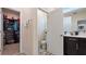 This bathroom features a neutral color scheme, a closet, tile floors, and an interior door at 9360 Meadow Hunt Way, Winter Garden, FL 34787