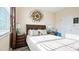 Well-lit bedroom with wood-look floors, a large window, and a decorative wall hanging at 9360 Meadow Hunt Way, Winter Garden, FL 34787