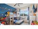 Fun bedroom with bunk beds, space themed decals, and a blue accent wall at 9360 Meadow Hunt Way, Winter Garden, FL 34787