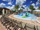 Gathering-friendly community pool area features colorful water slides and plenty of seating at 9360 Meadow Hunt Way, Winter Garden, FL 34787