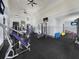 Well-equipped gym with modern exercise equipment, ceiling fans, and mounted TVs at 9360 Meadow Hunt Way, Winter Garden, FL 34787