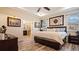 Inviting main bedroom with a tray ceiling, en-suite bathroom access, and contemporary furnishings at 9360 Meadow Hunt Way, Winter Garden, FL 34787