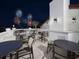 Charming rooftop terrace with tables and seating, offering stunning views of the fireworks at 9360 Meadow Hunt Way, Winter Garden, FL 34787