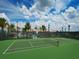 Outdoor tennis court for residents to enjoy with lush green surroundings and blue sky at 9360 Meadow Hunt Way, Winter Garden, FL 34787