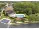 Aerial view showcasing a community pool, playground, clubhouse, landscaping, and parking at 9559 Silver Buttonwood St, Orlando, FL 32832