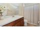 Bathroom vanity area featuring cabinets, white countertops, and decorative flowers at 1191 Terralago Way, Kissimmee, FL 34746