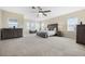 Large bedroom featuring a ceiling fan, neutral carpeting, large windows, and plenty of space at 1191 Terralago Way, Kissimmee, FL 34746