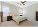 Spacious bedroom with neutral tones, featuring a large bed, ceiling fan, and ample natural light at 1191 Terralago Way, Kissimmee, FL 34746