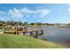 Charming dock on a quiet lake, surrounded by lush greenery, providing a perfect spot for fishing and relaxation at 1191 Terralago Way, Kissimmee, FL 34746