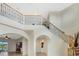 Spacious foyer with a staircase and wrought iron railing at 1191 Terralago Way, Kissimmee, FL 34746