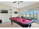 Spacious game room featuring a pool table and access to an outdoor patio with scenic waterfront views at 1191 Terralago Way, Kissimmee, FL 34746