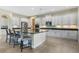 Well-equipped kitchen featuring an island with bar seating, white cabinetry, and stainless steel appliances at 1191 Terralago Way, Kissimmee, FL 34746