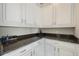 Pantry featuring granite countertops, white cabinets, and plenty of storage space at 1191 Terralago Way, Kissimmee, FL 34746