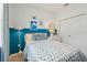 Comfortable bedroom featuring blue and white color scheme, decorative artwork, window with curtain, and closet at 1206 Normandy Dr, Haines City, FL 33844