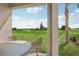 Scenic view from a covered patio with seating, overlooking a lush green landscape on a sunny day at 1206 Normandy Dr, Haines City, FL 33844