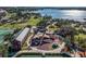 Aerial view of community playground with shade structures, surrounded by lush greenery and a lake view at 1206 Normandy Dr, Haines City, FL 33844